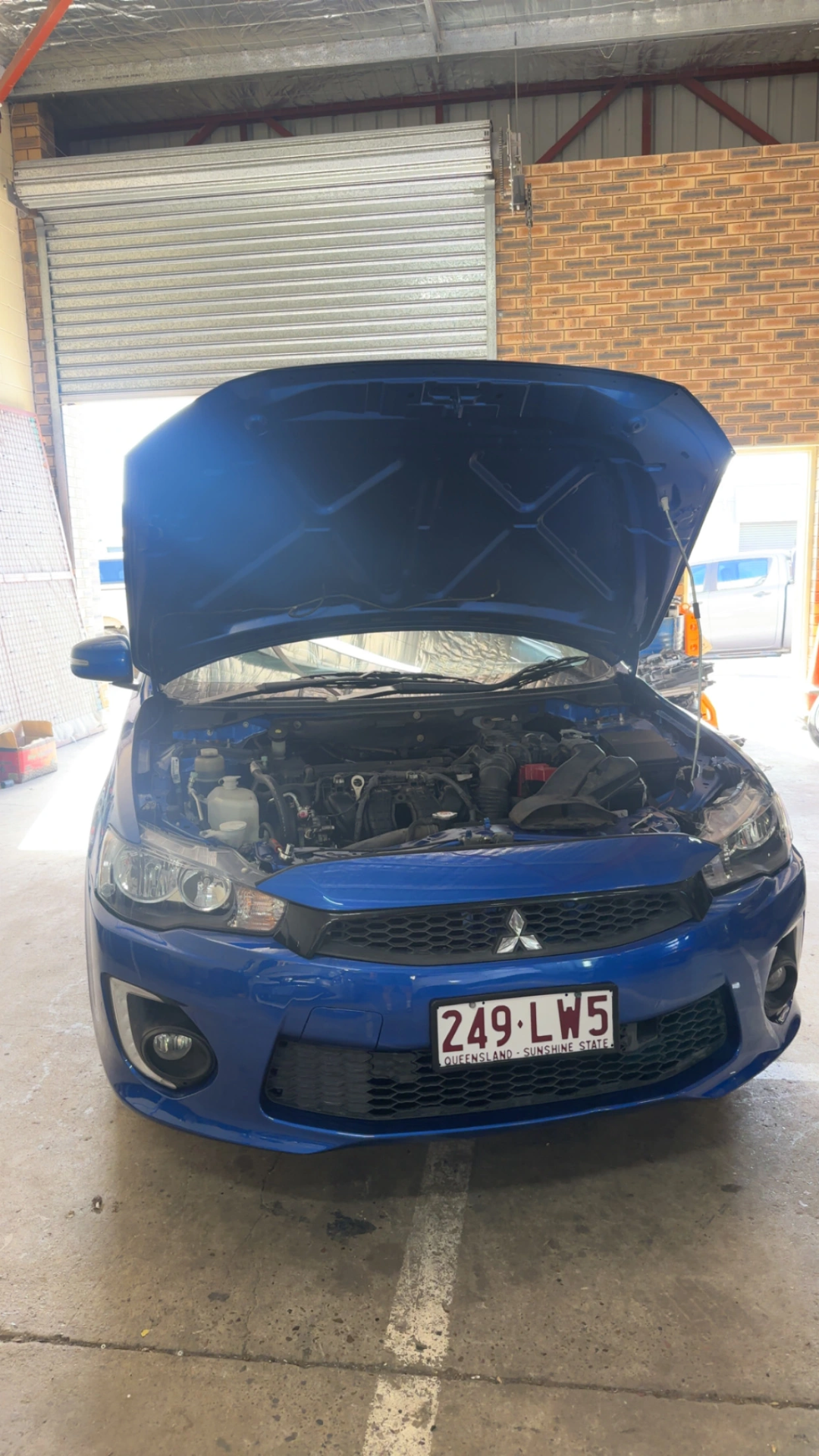 Blue Mitsubishi sedan in for repair at the Woodridge workshop